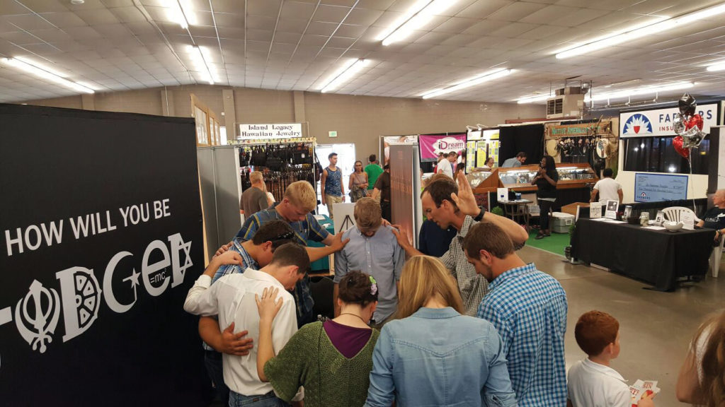 Believers praying for Ty at the Lynden Fair Witness Booth