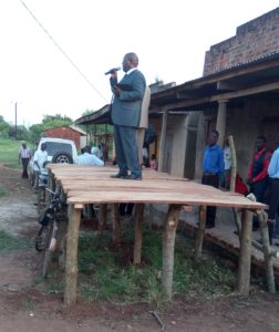 Brother Ibale doing outreach near Brother Mugabi's church