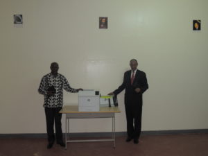 Pastor Rwigamba Balinda (at right) with new print station & cutter