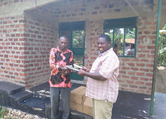 Pastor Innocent of Nazigo, Uganda receiving Bibles